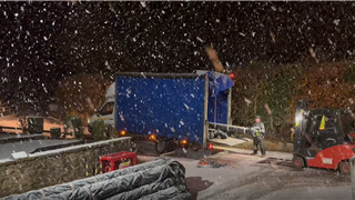 Packing a delivery on a snowy evening