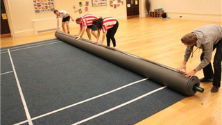 Rolling up the Verde Badminton Court