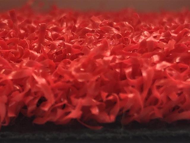 side view of red artificial grass