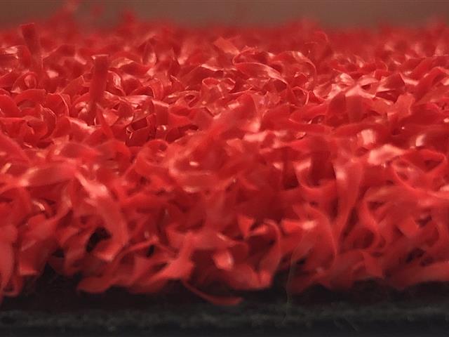side view of red artificial grass